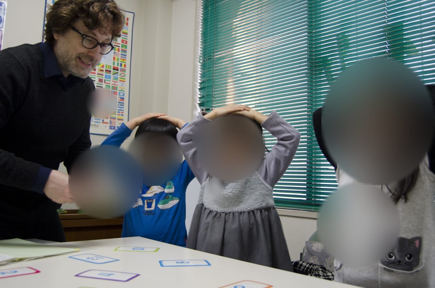 Mark leading “Heads, shoulders, knees and toes” in a children's class